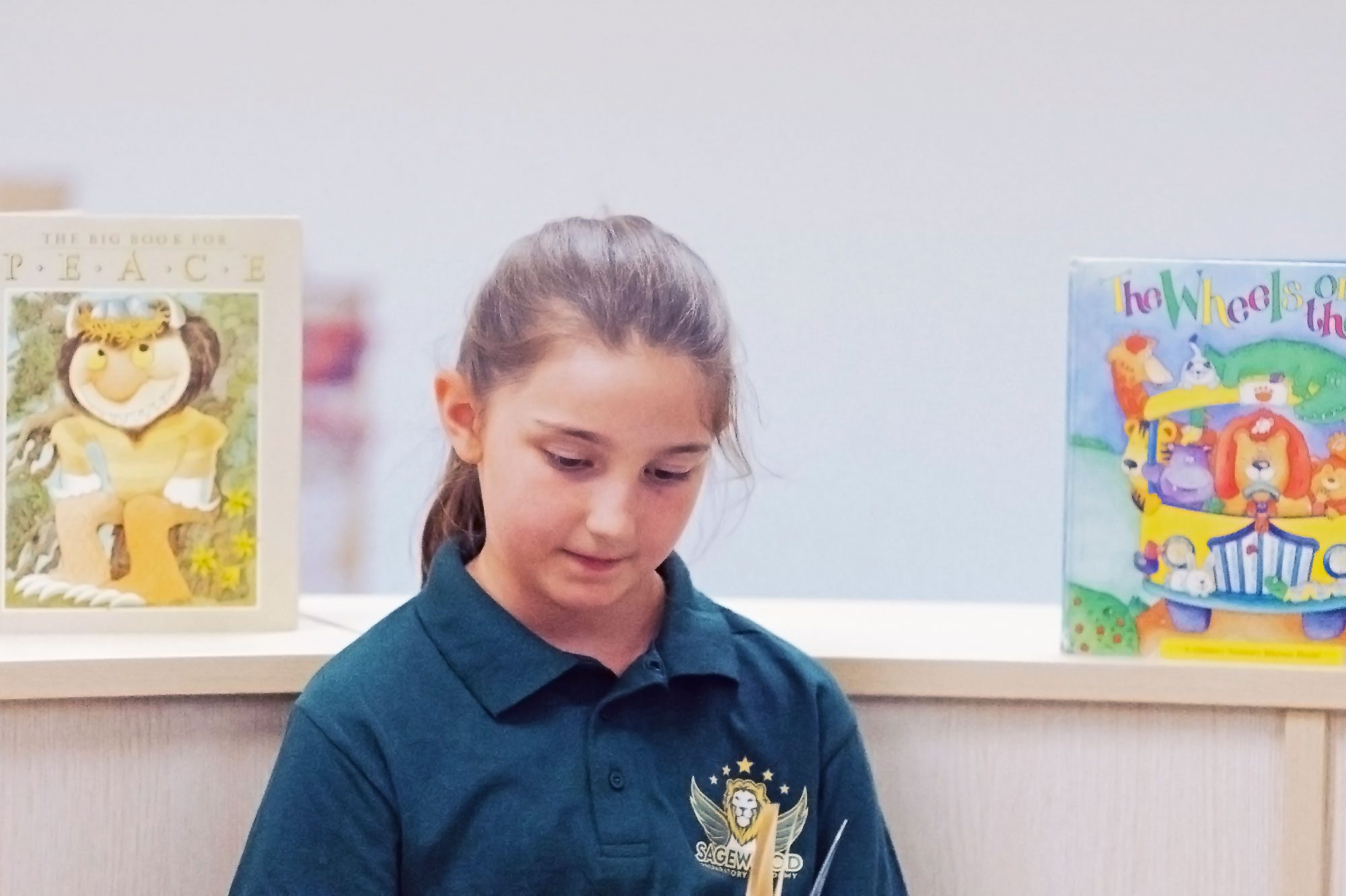 Student reading a book in the school library